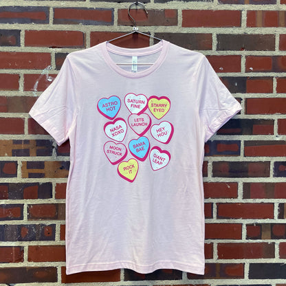 Thumbnail of conversation hearts with "space themed" sayings on pink t-shirt
