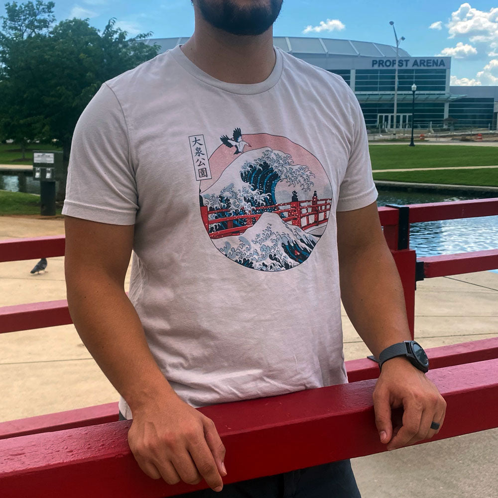 Image of man standing in Big Spring Park wearing "The Great Wave" over Japanese Friendship Bridge at Big Spring Park t-shirt