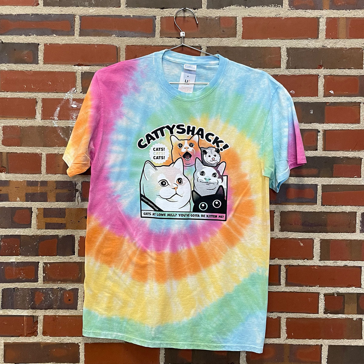 A tie dye t-shirt with famous internet cats advertising "cattyshack"